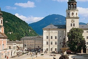a large building with a mountain in the background