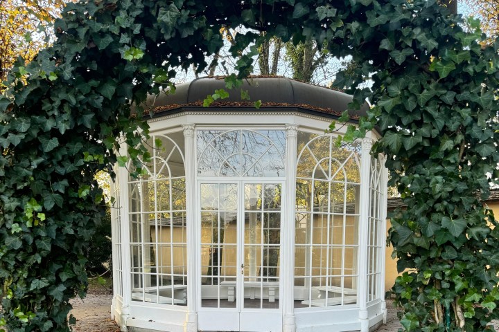 a house with bushes in front of a window