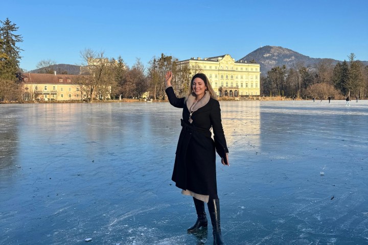 a woman standing in front of a body of water