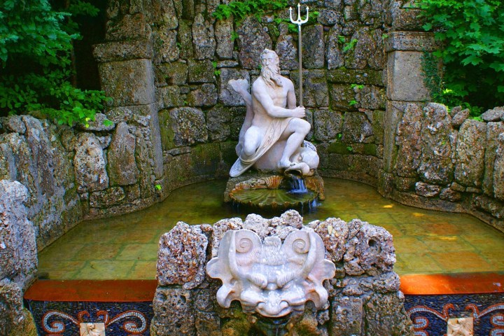 a statue sitting on a rock