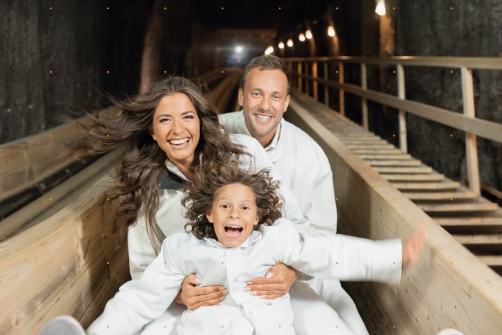 a person sitting on top of a wooden fence