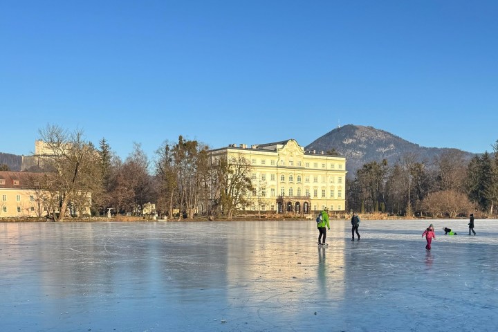 a group of people standing next to a body of water