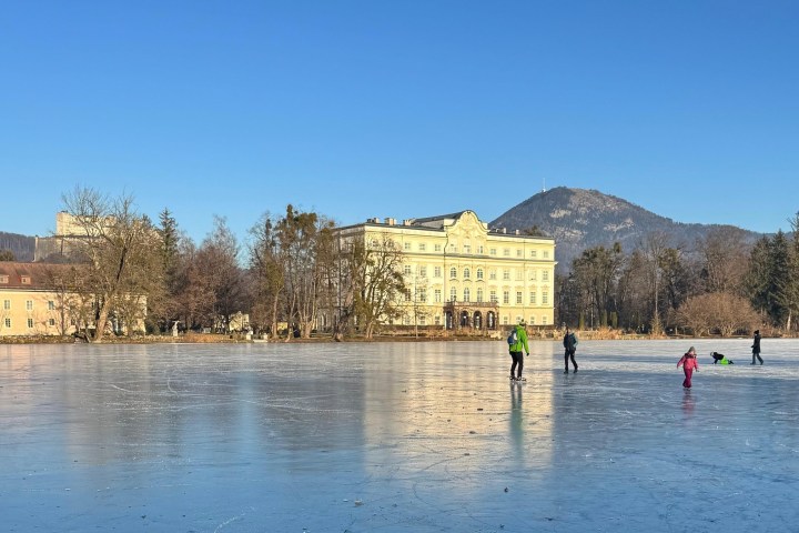 a group of people standing next to a body of water