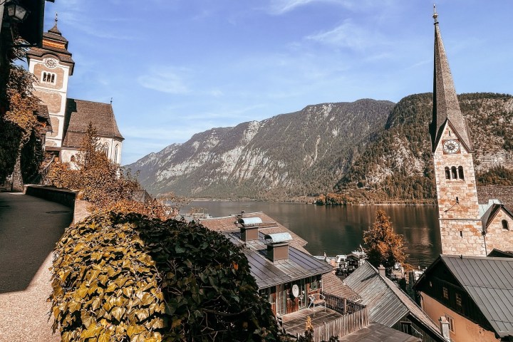 a large stone building with a mountain in the background