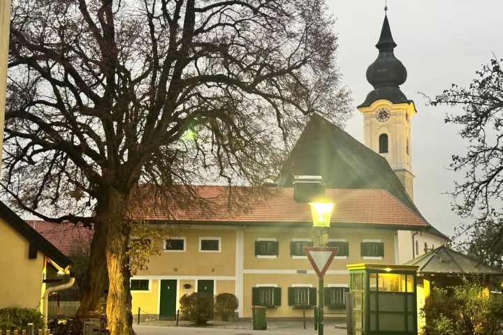 a house with trees in front of a building