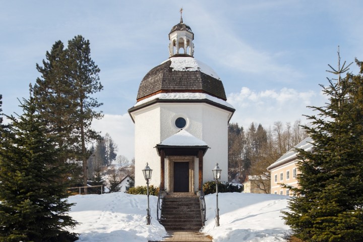 a small clock tower in the snow