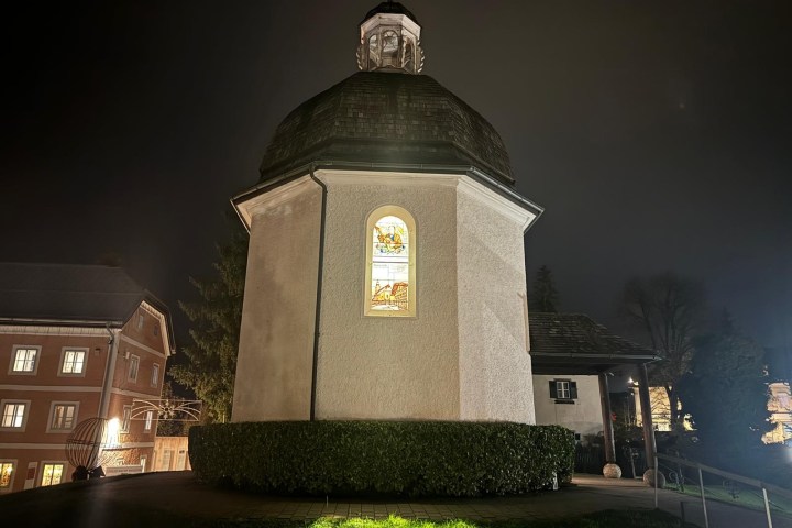 a castle with a clock tower lit up at night