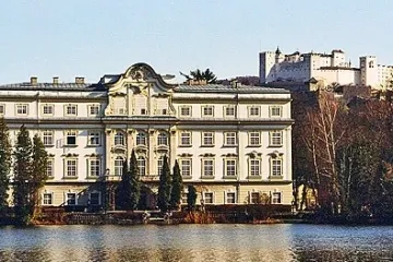 a castle with water in front of a building