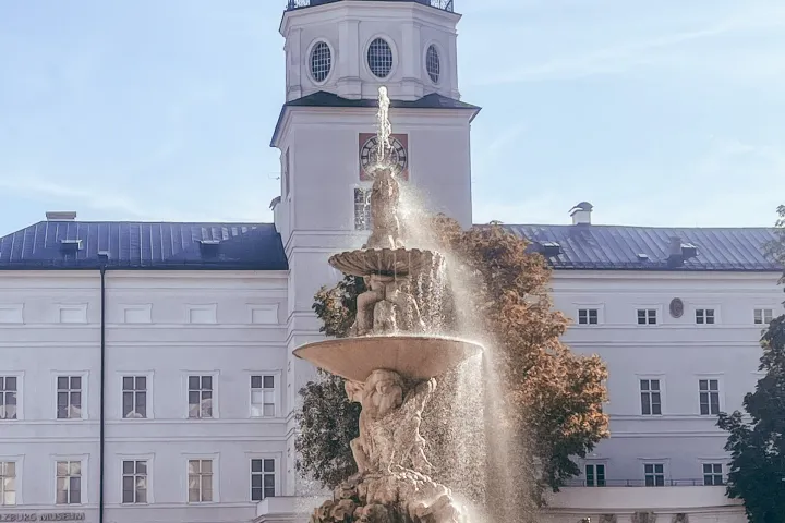 a large stone statue in front of a building