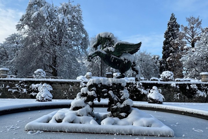 a parking meter covered in snow