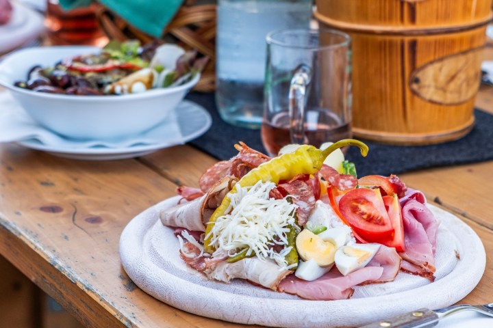 a plate of food sitting on top of a wooden table