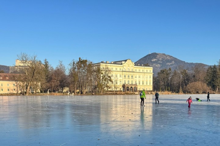 a group of people standing next to a body of water