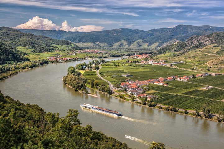 a large body of water with a mountain in the background